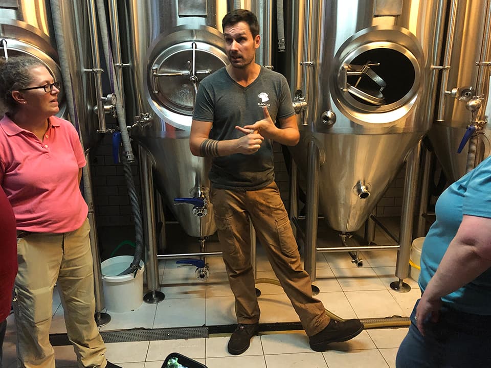 Matt, the American-expat founder and brewer of Barcelona’s BlackLab, welcomes ICBT to his workplace near the harbor.